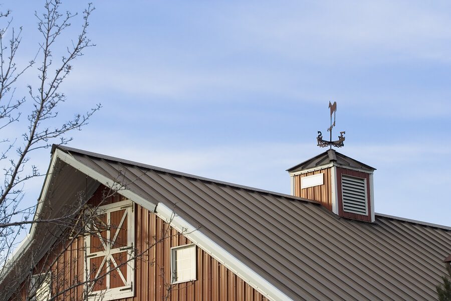Close-up of red barn with metal roof