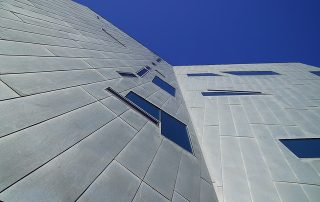 Example of modern cladding, grey metal cladding on new building showing asymmetrical windows and building exterior