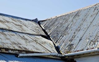Broken corrugated iron roof sheets on an old abandoned house
