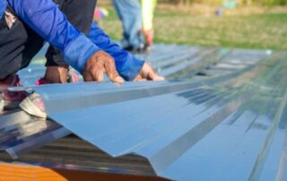 Person Handling Roofing Sheets For Small Projects In Queensland.